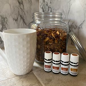 Granola in jar with Vitality oils and coffee cup