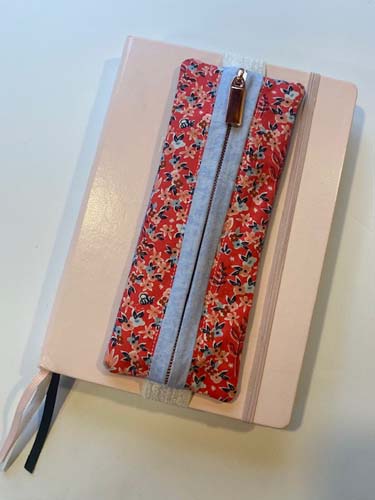 Pink and blue journal case with rose gold zipper - displayed on a journal