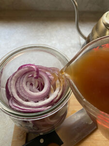 Pour mixture over the sliced red onions